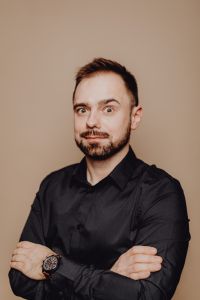 Playful Man in Black Shirt with Crossed Arms, Quirky Studio Portrait for Personal Branding