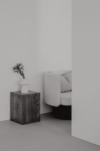 Kaboompics - Monochrome Minimalist Interior with Walnut Pedestal and Upholstered Armchair