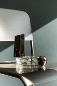 Minimalist Metal Object Still Life With Blue Geometric Background