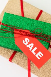 Kaboompics - Close-Up Sale Tag and Red Cord on Green Gift Wrap