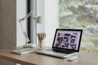 Kaboompics - Wide Home Office Desk with Laptop and Work Supplies beside a Large Green Window