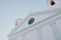 Kaboompics - White Church Facade and Cross Against a Pale Sky in Calasetta