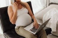 Kaboompics - Pregnant Woman on a Phone with Laptop at Home