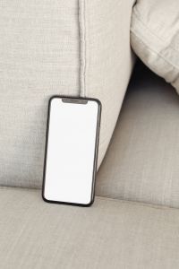 Kaboompics - Blank Smartphone Mockup Beside a Linen Sofa Seam