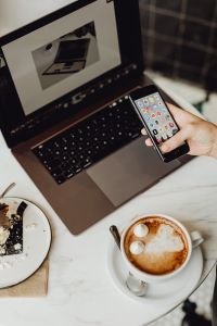 Kaboompics - Working with a laptop & iPhone X, meringue with whipped cream and coffee on white marble