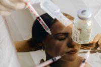 Kaboompics - Cosmetic Injection Syringe Above Woman’s Face