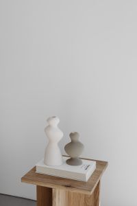 Kaboompics - Small Ceramic Vases and Art Book on a Wooden Side Table