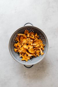 Kaboompics - Golden Chanterelles in a Metal Colander