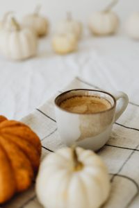 Kaboompics - Coffee Cup with Orange and White Pumpkins