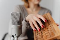 Kaboompics - Woman Playing a Wooden Sound Prop beside Studio Microphone for ASMR