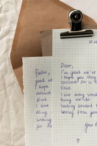 Kaboompics - Two Handwritten Letters on Grid Paper with Kraft Clipboard