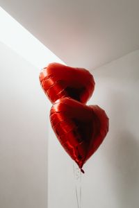 Kaboompics - Two Red Heart Balloons in a Bright White Interior
