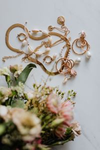 Kaboompics - Gold jewellery on white marble - necklace, bracelets, earrings