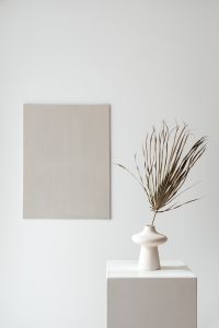 Kaboompics - White Sculptural Vase with Dried Branches beside Beige Canvas