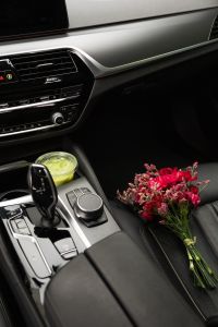 Kaboompics - Matcha Drink and Flower Bouquet in a Car Interior
