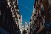Kaboompics - Crane Spanning a Narrow Madrid Street Between Historic Apartment Facades