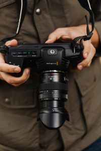 Kaboompics - Hands Holding Blackmagic Camera with 12-35mm Zoom Lens