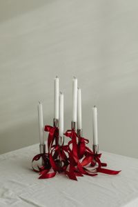 Kaboompics - White Taper Candles Decorated with Cascading Red Ribbons