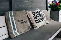 Kaboompics - Handmade Typography Pillows on Gray Bench