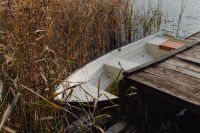 Kaboompics - Small Rowboats Moored Beside a Weathered Wooden Dock