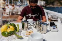 Kaboompics - Cups, silver jugs with coffee, Italian cookies and lemons on the table