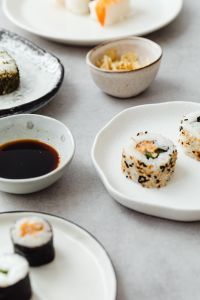 Kaboompics - Japanese Sushi Table Spread with Ceramic Plates and Soy Sauce