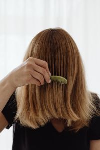 Kaboompics - Jade Comb Drawn Through Long Hair in Close-Up