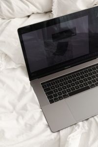 Kaboompics - Laptop Screen and Keyboard on Soft White Bedding