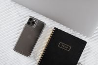 Kaboompics - Silver Smartphone, Laptop Corner and 2020 Planner on Pale Marble