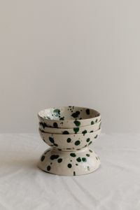 Kaboompics - Stacked Green Splatter Bowls with Tall Neutral Copy Space