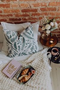 Kaboompics - Croissants and figs on a green plate, a cup of coffee and a candle, a notebook