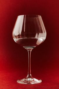 Kaboompics - Brandy Snifter on Bold Red Background