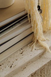 Kaboompics - Travertine Surface with Books and Fringed Textile Detail