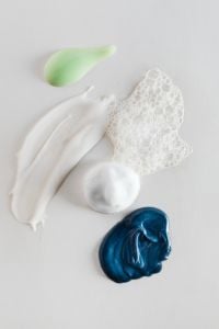 Kaboompics - Skincare Cream and Foam Swatches in White, Mint and Navy on a Light Background