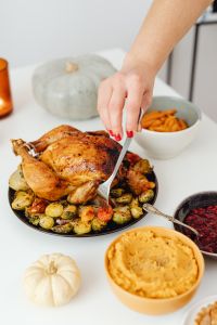 Kaboompics - Fork Cutting Roast Turkey with Vegetables at Thanksgiving