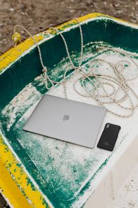Kaboompics - MacBook and Smartphone Inside a Weathered Yellow Dinghy