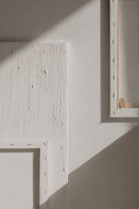 Kaboompics - Textured White Paint Board Against a Shadowed Studio Wall