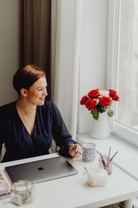Happy casual beautiful woman working on a laptop