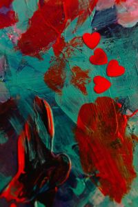 Kaboompics - Red Heart Confetti on Teal and Red Abstract Paint