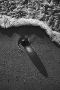 Kaboompics - Black and White Glass Sphere Casting a Shadow on Sand