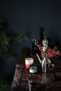 Rustic Christmas Still Life with Holly, Candles and Coffee on a Wooden Table