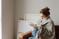 Kaboompics - Cozy Sofa Reading: Woman Wrapped in a Blanket at Home
