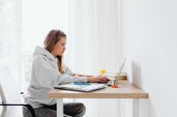 Kaboompics - Teenager Studying at Desk with Laptop and Notebook