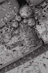Kaboompics - Black and White Disco Balls and Confetti Across Sofa Cushions