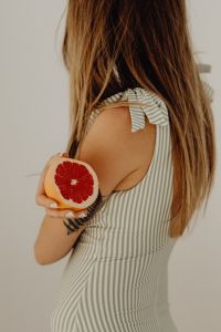 Kaboompics - Grapefruit Half in Front of a Striped Swimsuit, Summer Food Detail