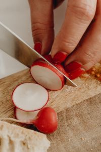 Kaboompics - Close-Up of Slicing Radishes on a Wooden Board