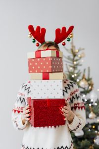 Kaboompics - Woman Wearing Reindeer Antlers Holding Three Christmas Gift Boxes