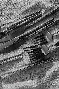 Kaboompics - Monochrome Matte Steel Forks and Knives in a Textured Cutlery Flat Lay