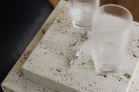 Kaboompics - Silver Jewelry and Glassware on a Travertine Table