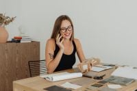 Kaboompics - Woman Talking on Phone While Holding Material Sample